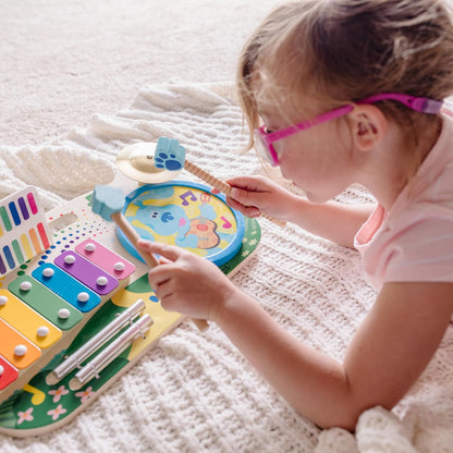 Child playing with melissa & doug wooden musical toy