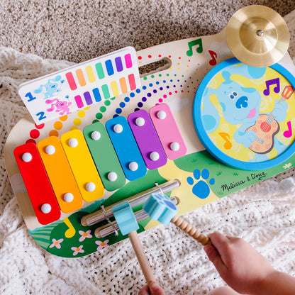 Child playing with wooden musical toy