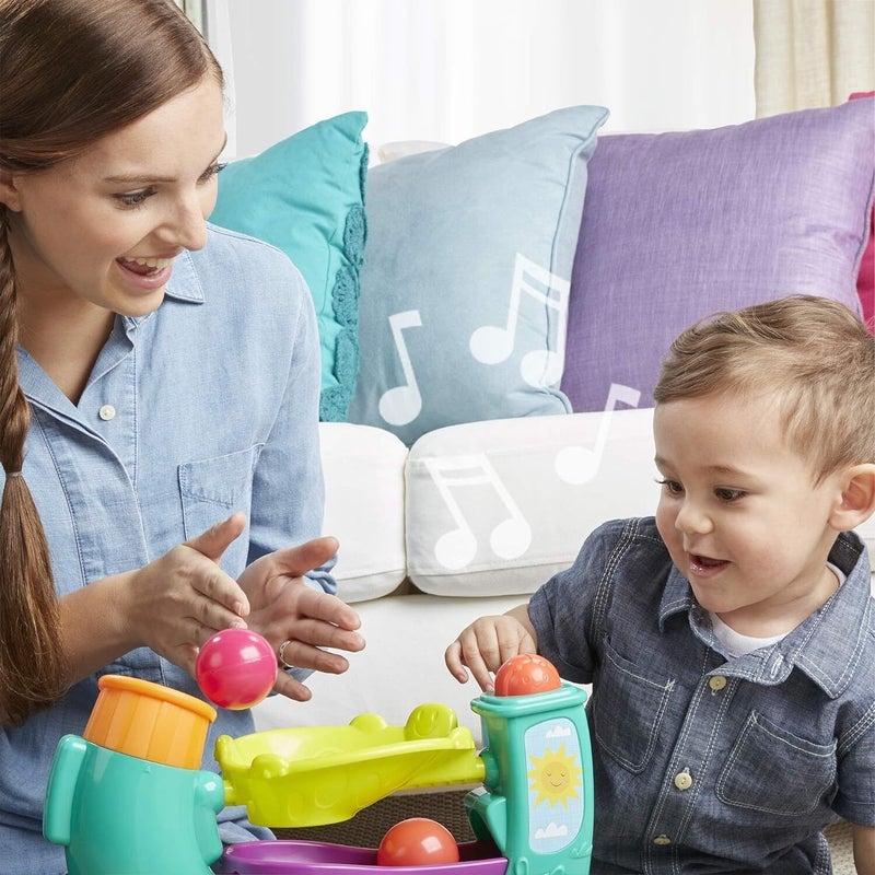 family using hasbro playskool ball popper toy