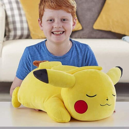 Child playing with pikachu plush toy